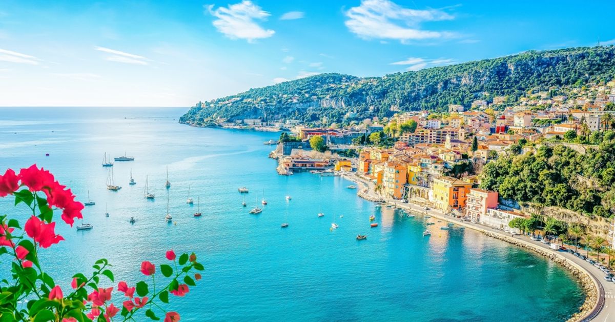 Villefranche-sur-Mer bay on the French Riviera with turquoise water, colourful buildings and sailboats