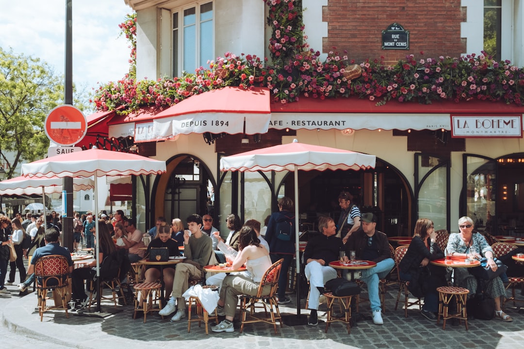 A bustling Parisian café terrace with diners enjoying al fresco meals — Photo by Nico Knaack on Unsplash