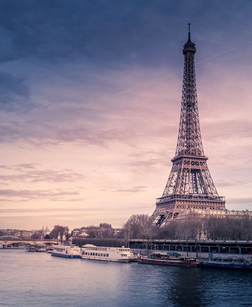 Paris cityscape with the Eiffel Tower and the River Seine at dusk — a classic first time in France view