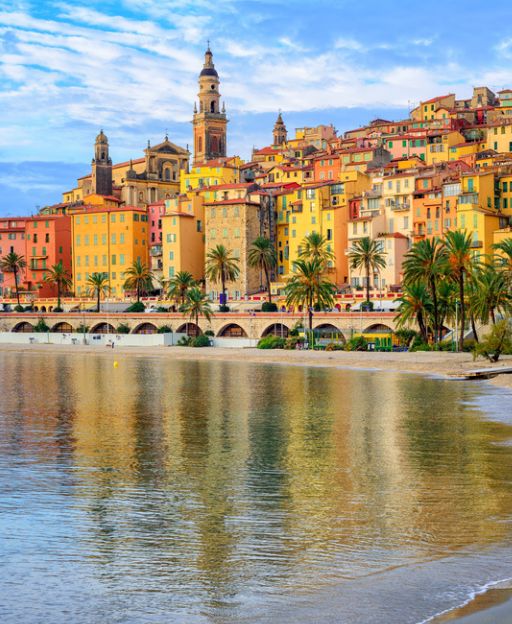 Menton's colourful old town rising above its sandy beach on the French Riviera