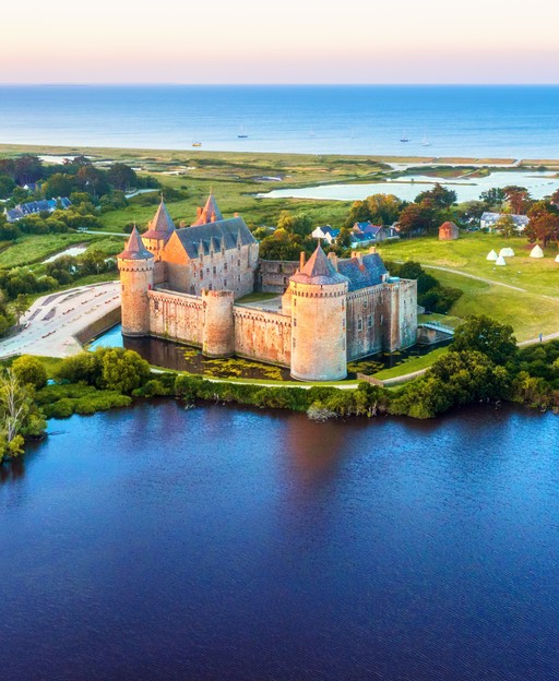 Suscinio Castle, the medieval residence of the Dukes of Brittany, surrounded by water and green landscape