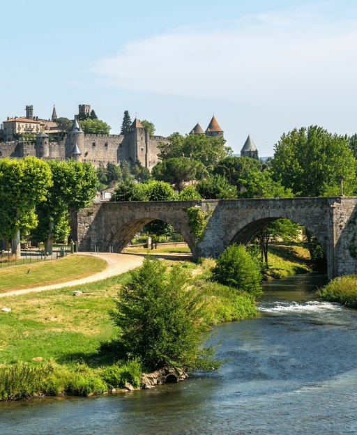 The medieval walled city of Carcassonne seen from across the River Aude with a stone bridge, Languedoc, France