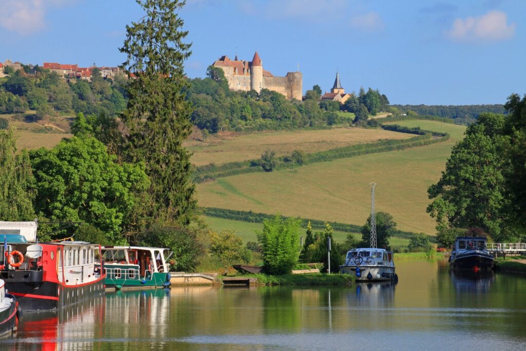 Châteauneuf-en-Auxois on its hilltop above boats on the Burgundy Canal