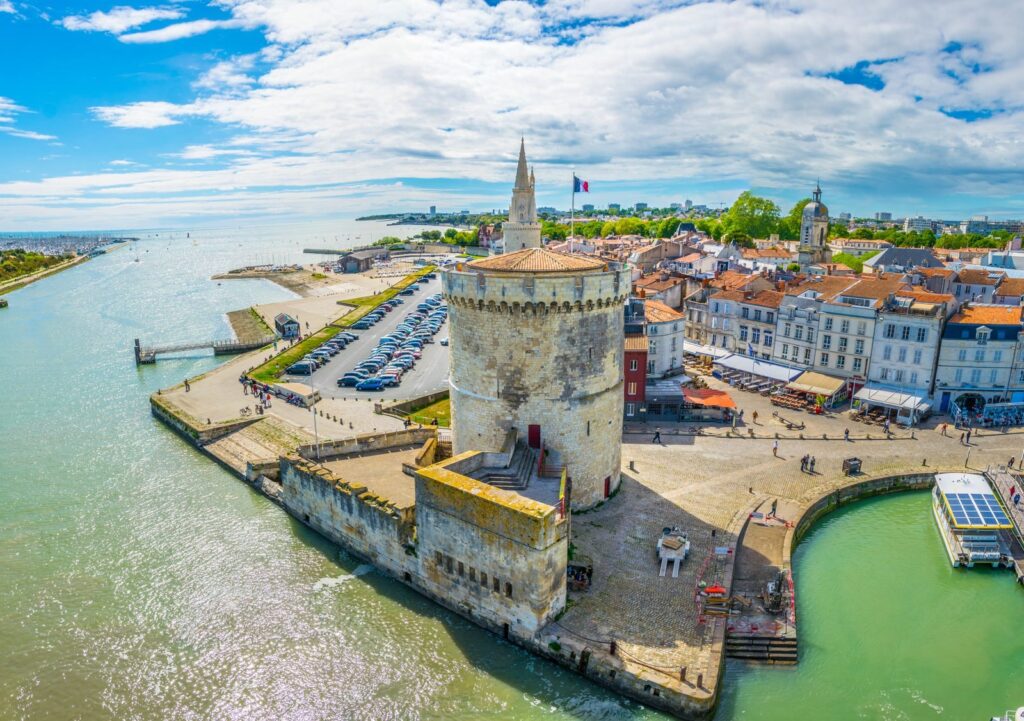 Tour de la Chaîne at the entrance to La Rochelle's old port, with the spire of the Tour de la Lanterne behind