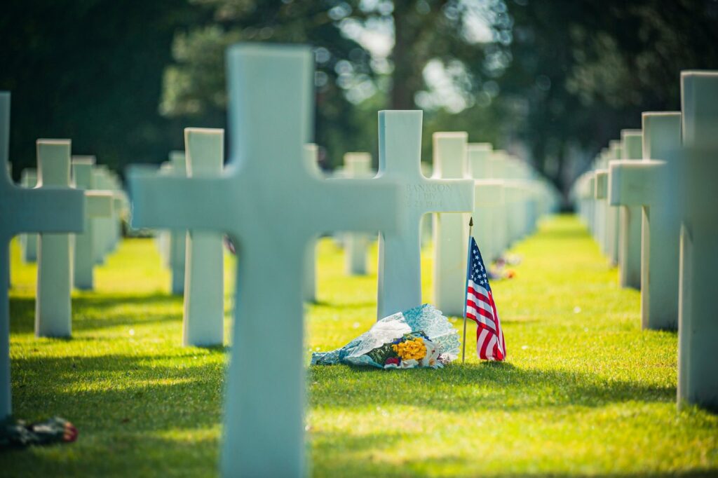 White crosses and an American flag at the Normandy American Cemetery above Omaha Beach