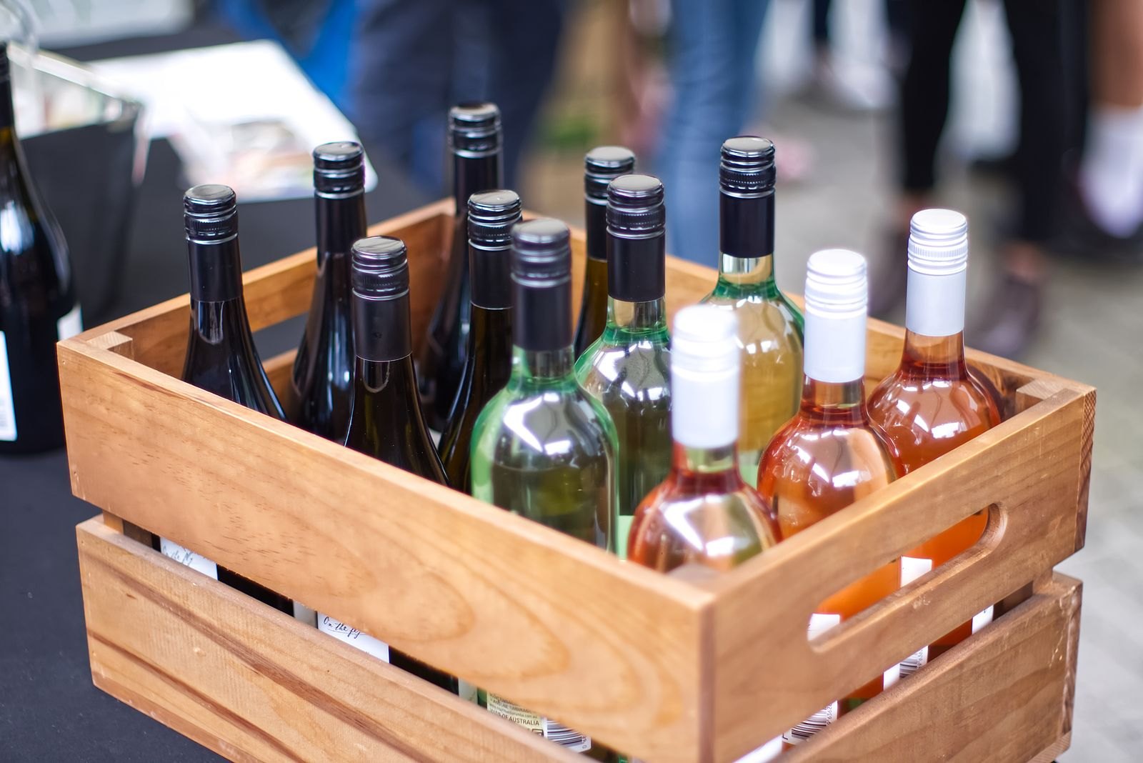 Crate of wine bottles at an outdoor tasting