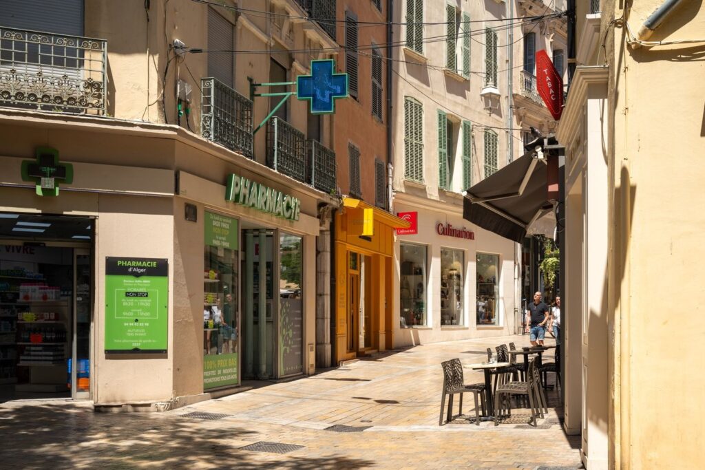 Pharmacy with its green cross on a street in Toulon