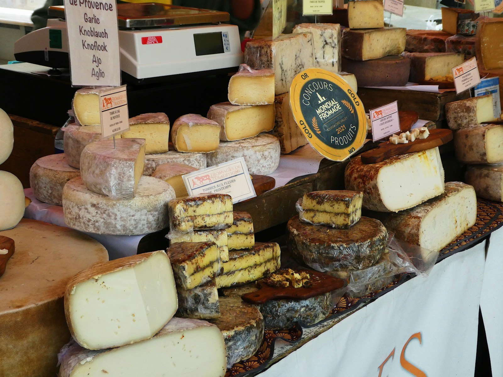 Wheels and wedges of cheese on a French market stall