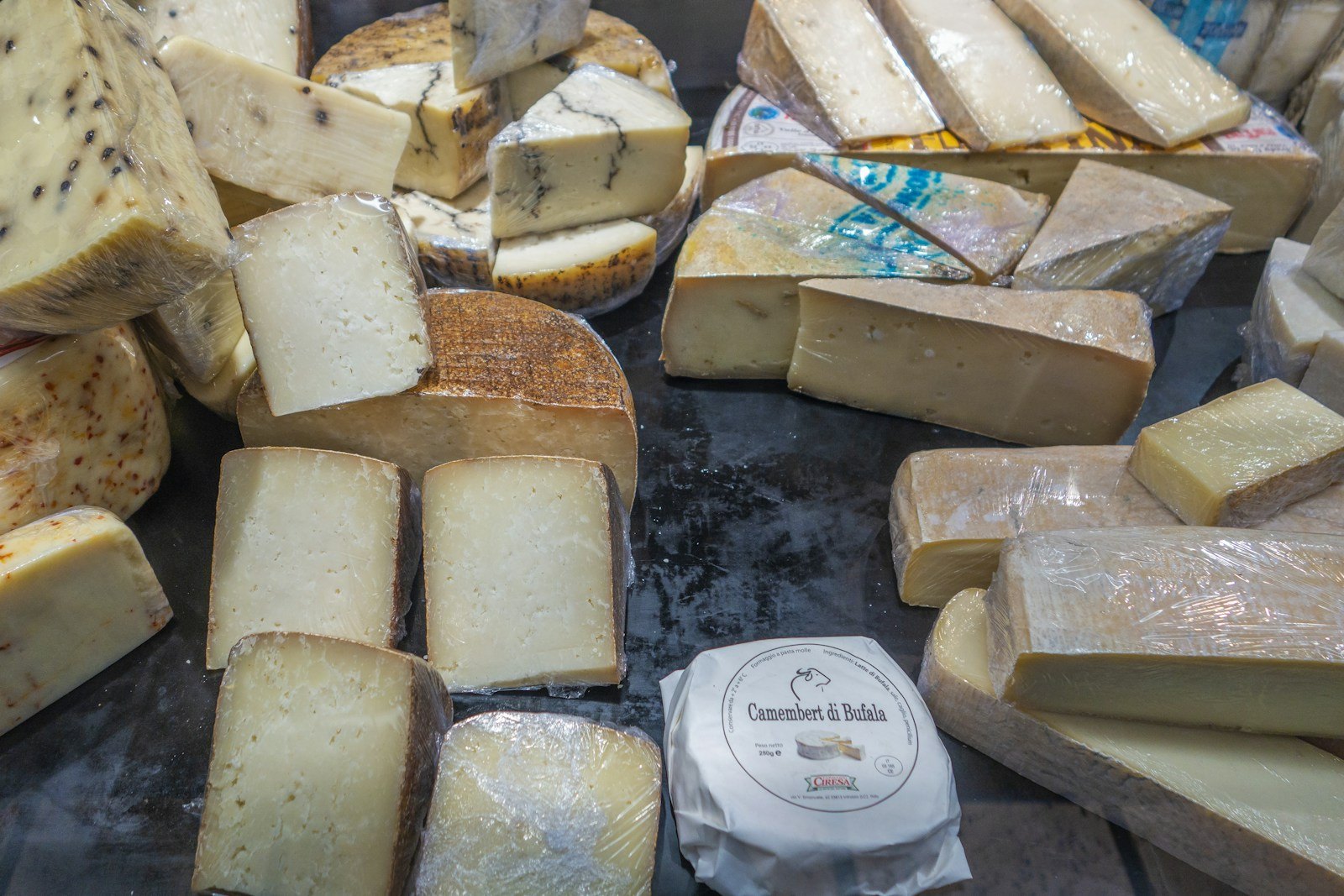 Cheeses in the window of a cheese counter at Les Halles Paul Bocuse, Lyon